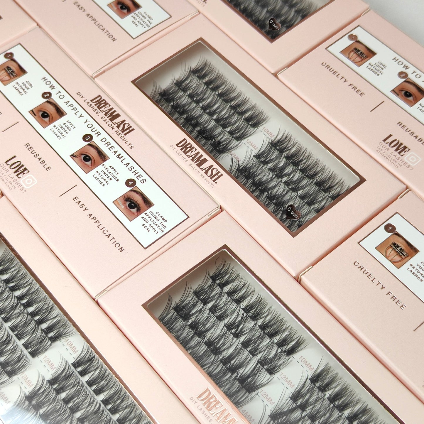 Set of false eyelashes in pink boxes with application instructions.