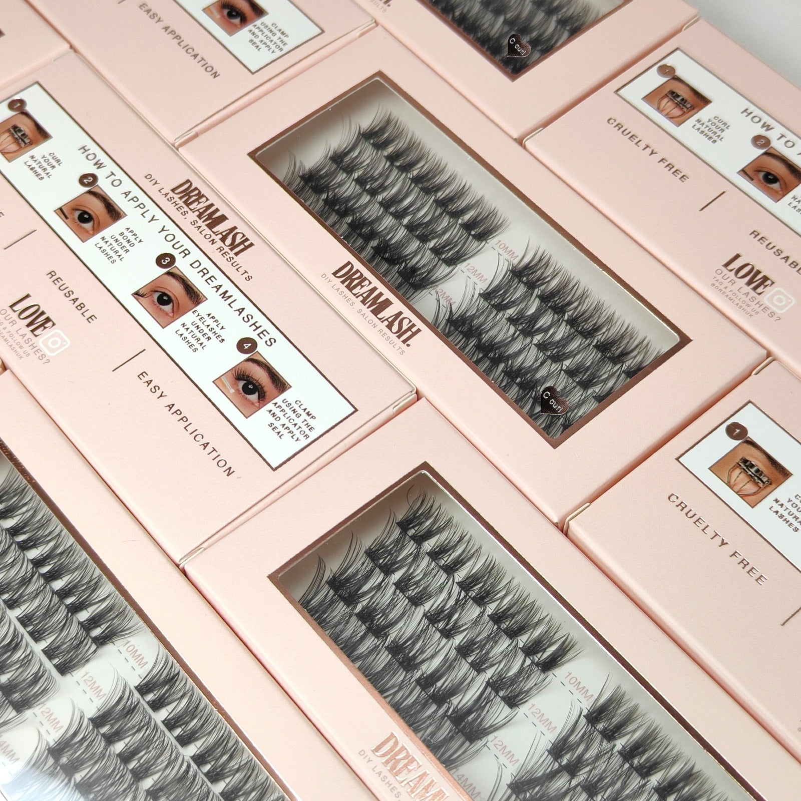 Set of false eyelashes in pink boxes with application instructions.