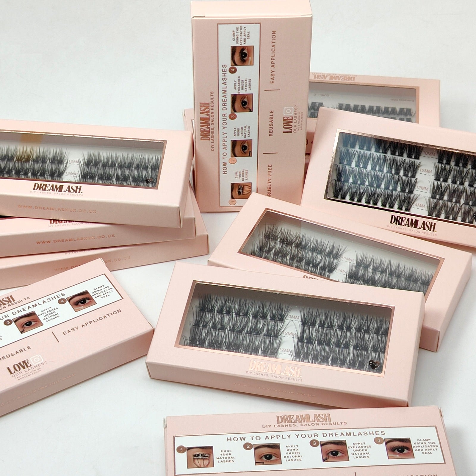 Multiple boxes of DreamLash false eyelashes on a light background