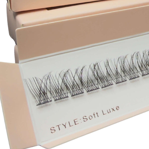 Box of false eyelashes with visible branding on a white background