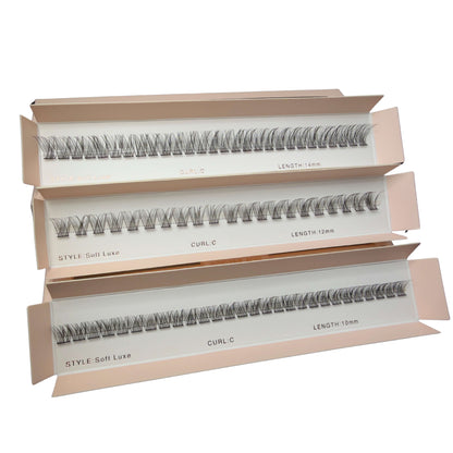 Three boxes of false eyelashes with different styles and lengths on a white background