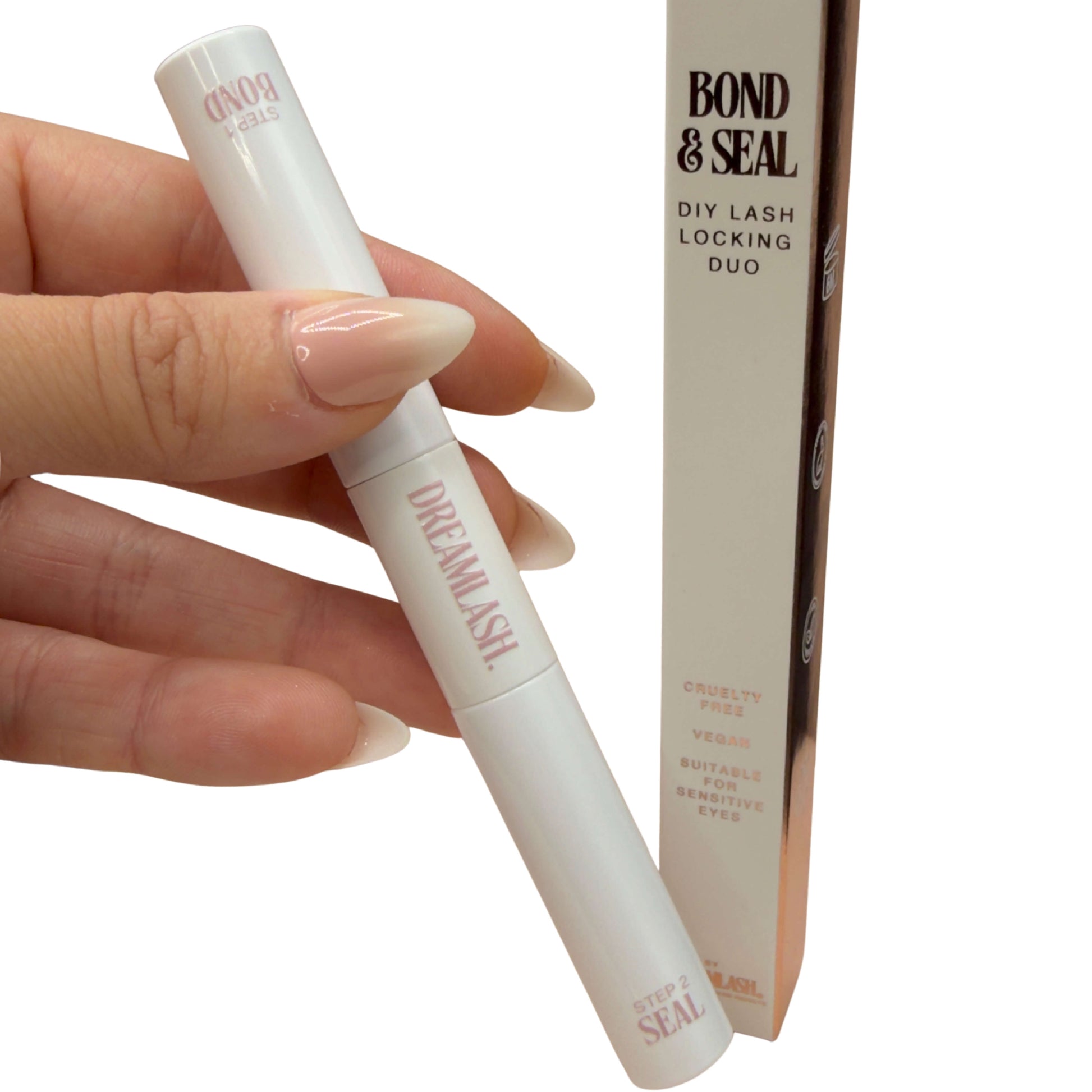 Hand holding a white cosmetic pen labeled 'Dream Lash' with 'Bond & Seal' packaging in the background.