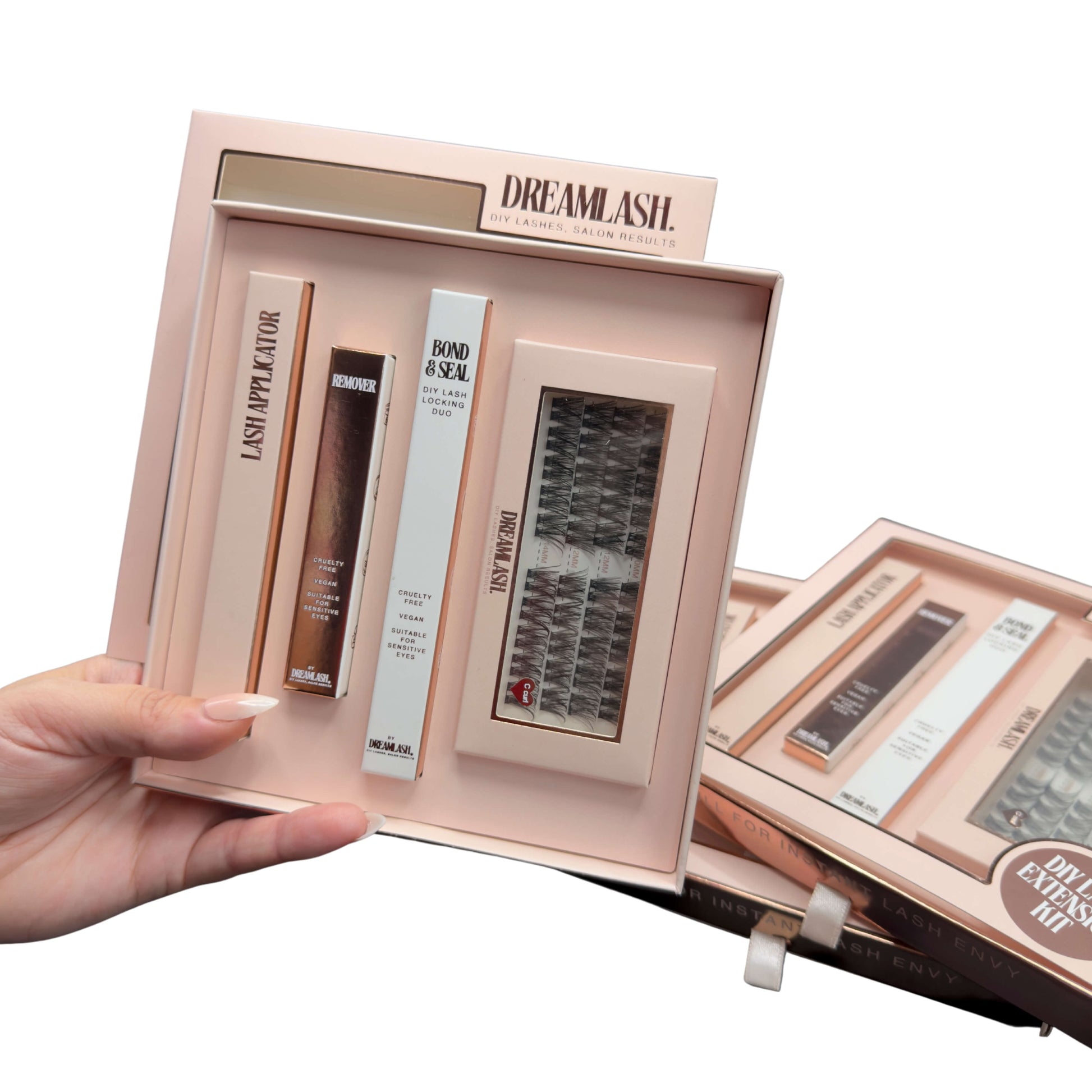 Open false eyelash kit with various components on a white background